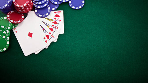 Royal flush and gambling chip on a green poker table