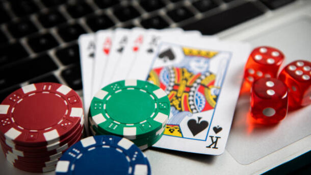 Poker chips and cards on computer keyboard