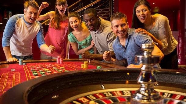 Group Of Friends Playing Roulette In Casino