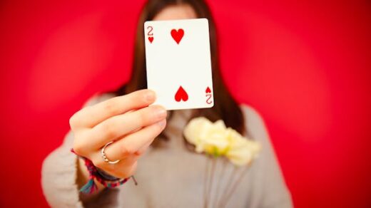 free-photo-of-woman-holding-a-two-of-hearts-card