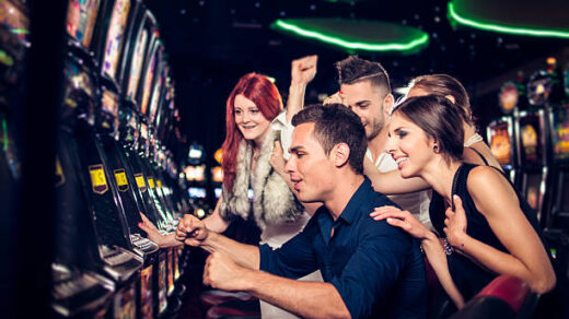 Group of people playing slot machines