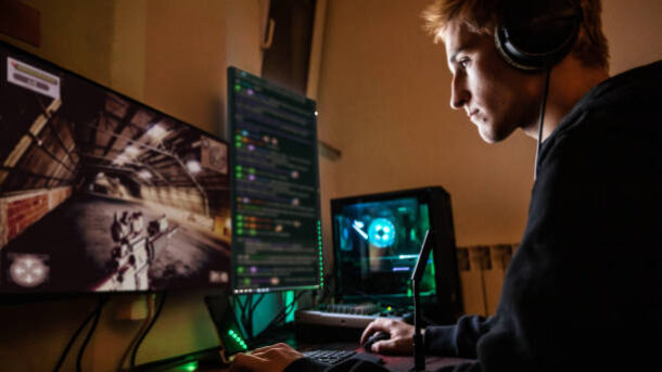 Teenage Boy Playing Multiplayer Games on Desktop Pc in his Dark Room